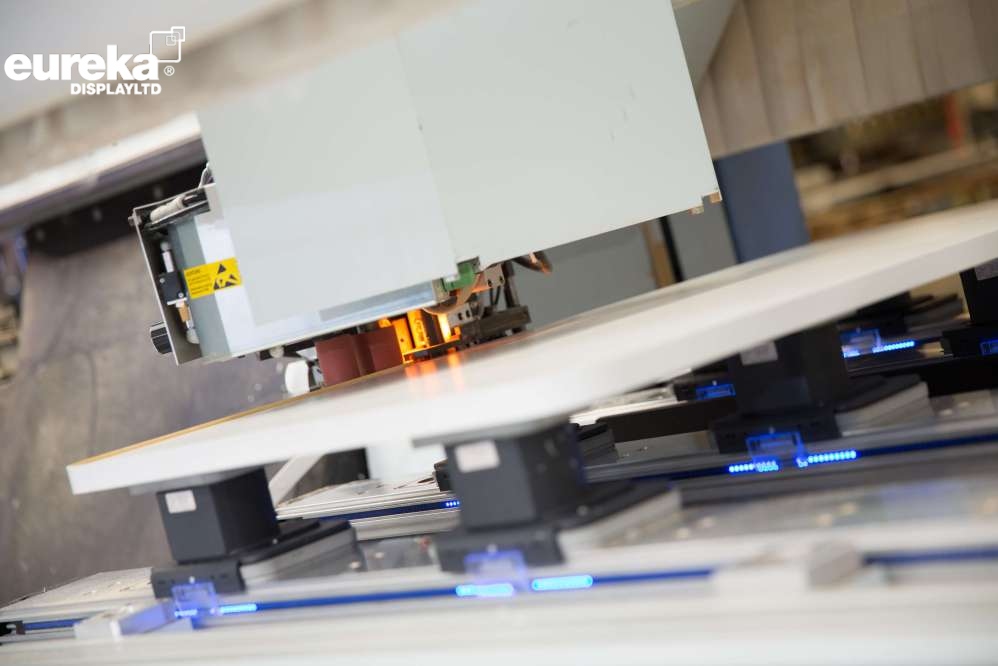 A radius edge band being placed on a board