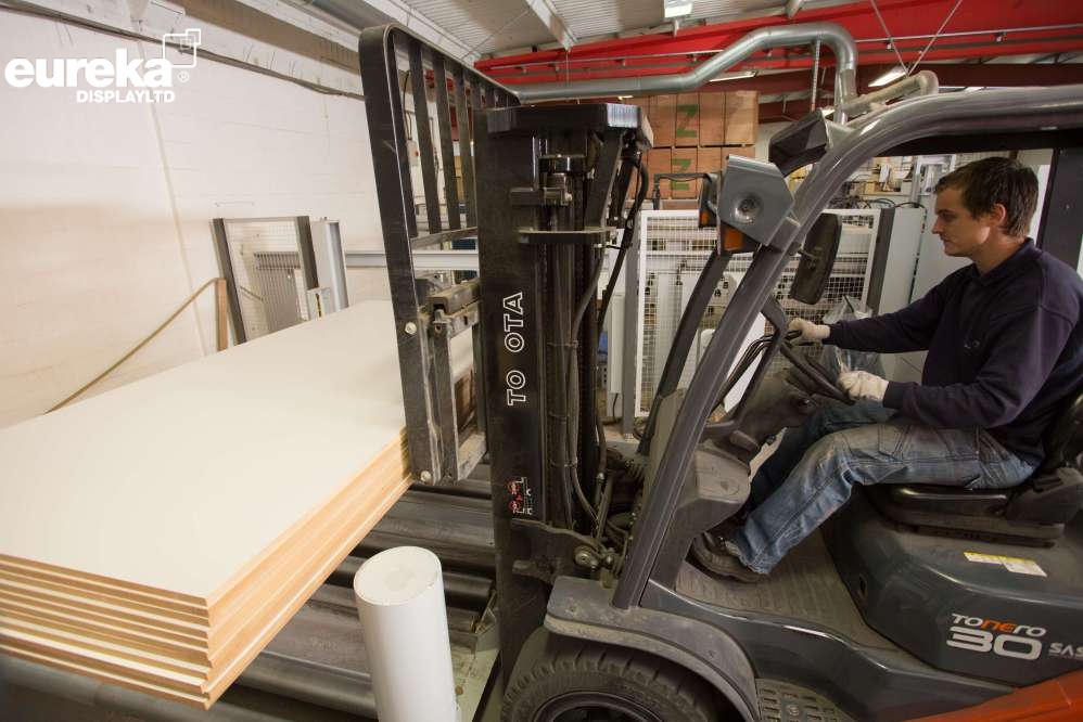 Boards whcih have been cut being picked up bya fork lift truck